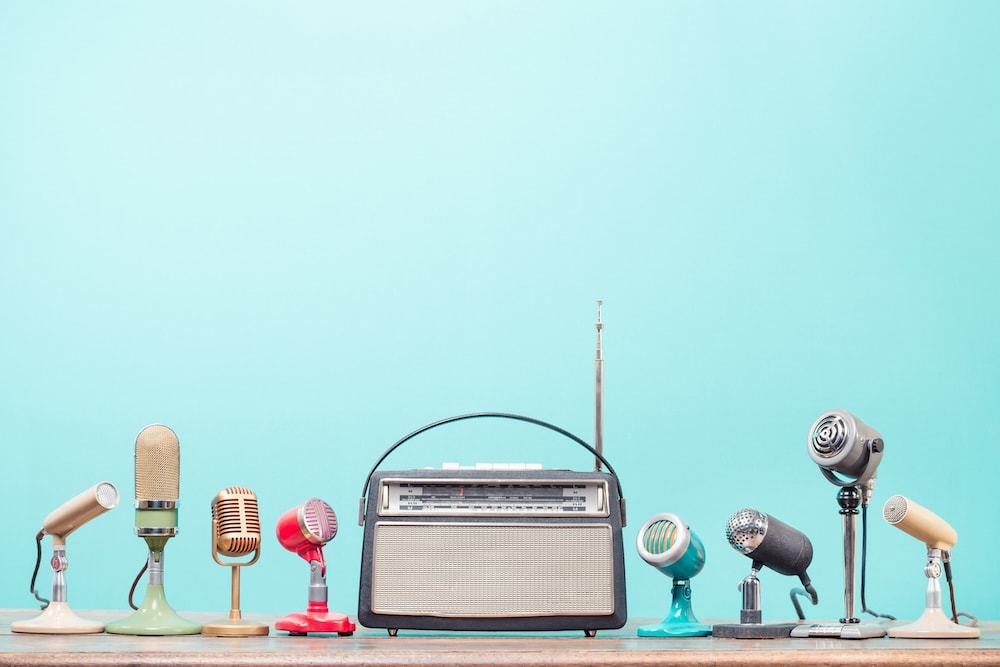 Alt text: Vintage microphones and a retro radio symbolising different voice styles in professional voiceover work.